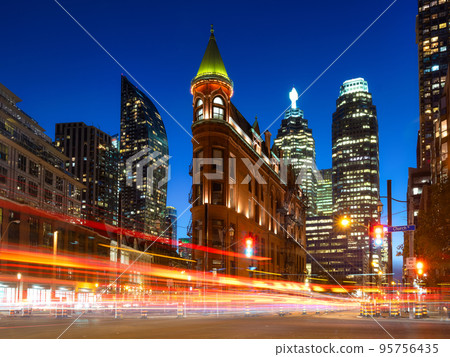 Canada, Toronto. The famous Gooderham building and the skyscrapers in the background. Canada, Toronto. The famous Gooderham building and the skyscrapers in the background. 95756435