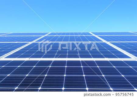 Solar panels lined up under a clear blue sky 95756745