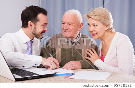 Woman and old man consider contract 95758181