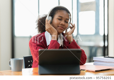 Portrait of beautiful young black woman using digital tablet. Portrait of beautiful young black woman using digital tablet. 95758201