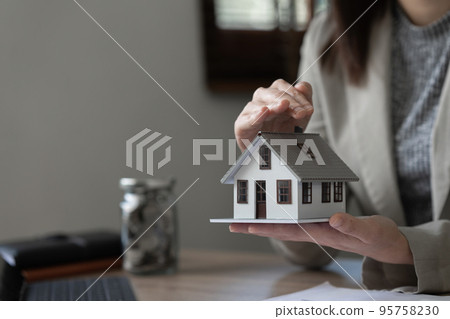Real estate agent and customer discussing for contract to buy house, insurance or loan real estate background 95758230