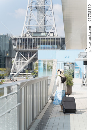 一名年輕女子拉著行李箱在名古屋觀光的背影 95758520