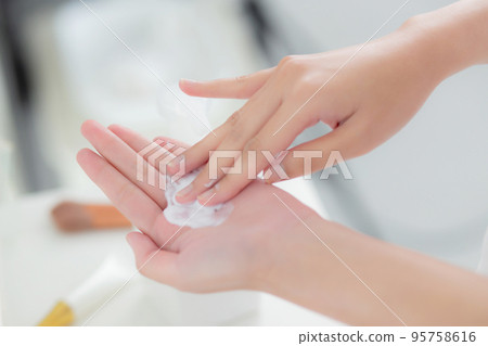 Closeup hands of woman applying moisturizer cream and lotion with hands for skin protection. Closeup hands of woman applying moisturizer cream and lotion with hands for skin protection. 95758616