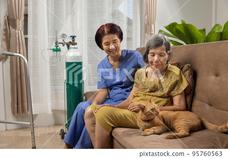 Elderly woman wearing oxygen nasal cannula at home. 95760563