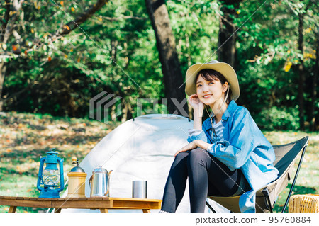 Young woman camping solo 95760884