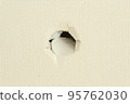A hole made by a child in the wall (close-up, horizontal composition) 95762030