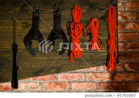 BDSM A set of toys for adults for erotic fantasies. Games for adults. Brick wall. Red room. BDSM A set of toys for adults for erotic fantasies. Games for adults. Brick wall. Red room. 95763007