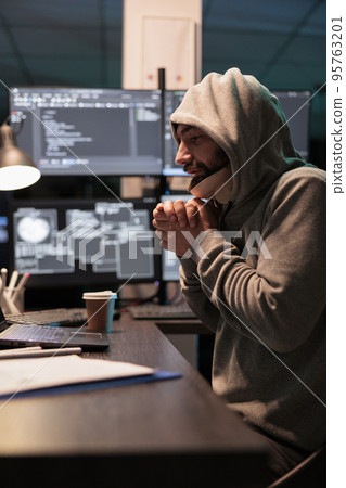 Male coder wearing cervical collar feeling cold in office working after hours on app developing code. Programmer with neck injury being sick in pain at work, coding late at night. 95763201