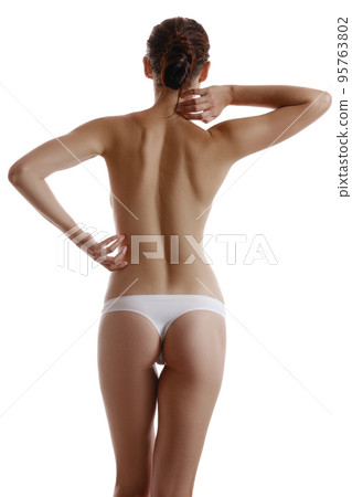 Woman in panties touching her spine, posing standing back to the camera, isolated on white. Plastic surgery, aesthetic cosmetology concept. Close-up. 95763802