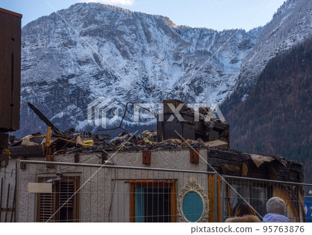 Wooden house affected by a fire caused by an electrical short circuit, in Hallstatt, a charming village in Salzkammergut region, Austria. Wooden house affected by a fire caused by an electrical short circuit, in Hallstatt, a charming village in Salzkammergut region, Austria. 95763876