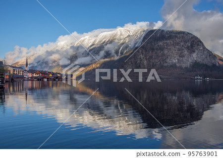 Hallstatt, a charming village on the Hallstattersee lake and a famous tourist attraction, with beautiful mountains surrounding it, in Salzkammergut region, Austria, in winter sunny day. Hallstatt, a charming village on the Hallstattersee lake and a famous tourist attraction, with beautiful mountains surrounding it, in Salzkammergut region, Austria, in winter sunny day. 95763901