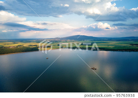 Aerial top view of beautiful landscape with large lake against mountains shapes at summer day. Mietkow lake near Wroclaw, Poland 95763938