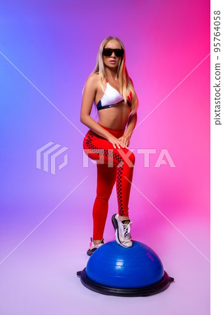 Stylish woman in underwear standing in neon light 95764058