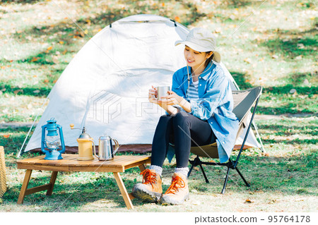 Young woman camping solo 95764178