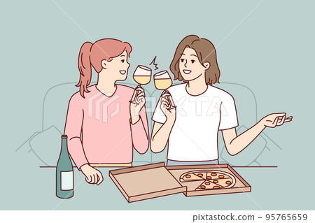Happy girls eat pizza drink wine 95765659