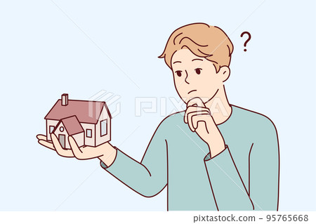 Young man thinking of house mortgage  95765668