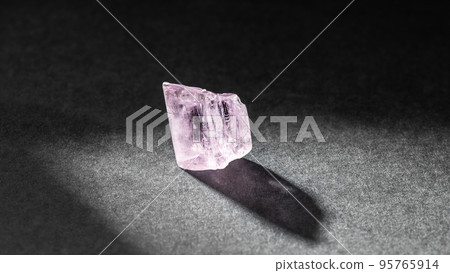 Kunzite crystal healing stone on black background 95765914