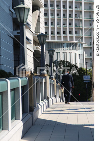 Businessman crossing the Dojima Bridge in the business district Businessman crossing the Dojima Bridge in the business district 95766529