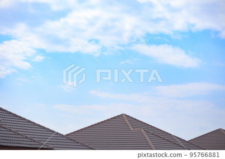 Ceramic roof tiles on the house with blue sky 95766881