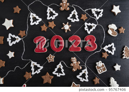 Set of numbers 2023 from ginger biscuits glazed sugar icing. Snowflakes, stars, gingerbread man. Set of numbers 2023 from ginger biscuits glazed sugar icing. Snowflakes, stars, gingerbread man. 95767406