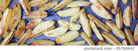 Baked apples with sugar cut into slices closeup 95768642