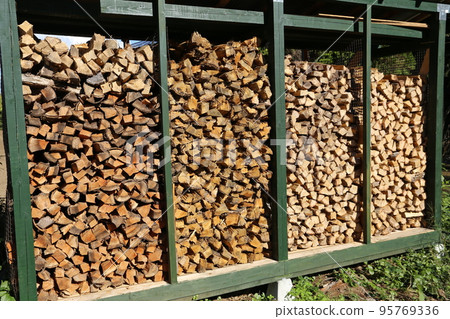Firewood dried and stored in the firewood shelf 95769336