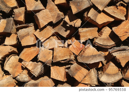 Firewood dried and stored in the firewood shelf Firewood dried and stored in the firewood shelf 95769338