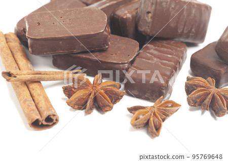 gourmet chocolate bonbons with anise and cinnamon sticks isolated on white background gourmet chocolate bonbons with anise and cinnamon sticks isolated on white background 95769648