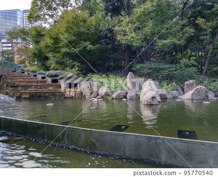 Garden with pond and stream 95770540