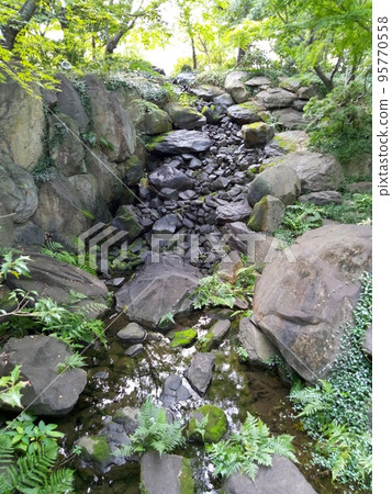 Garden with pond and stream 95770558