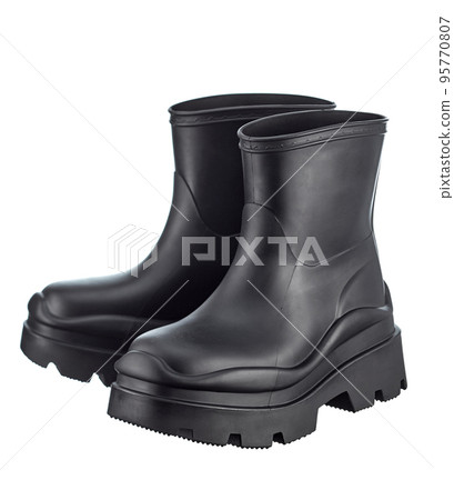 Fashionable rubber rain boots in black color of medium height, isolated on a white background. Unisex. 95770807