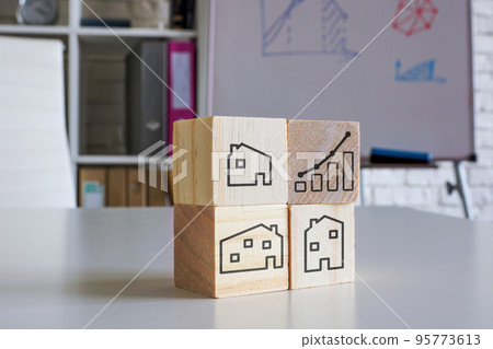 Real estate investment concept. Wooden cubes with houses and chart. Real estate investment concept. Wooden cubes with houses and chart. 95773613