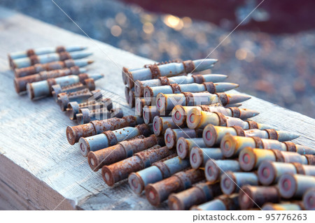 old rusty cartridges in a machine-gun belt. war in Ukraine. military ammunition old rusty cartridges in a machine-gun belt. war in Ukraine. military ammunition 95776263