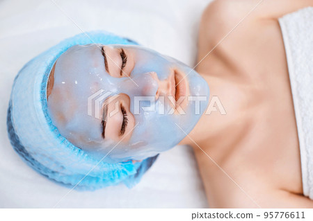 beautiful woman with blue alginate mask on face 95776611