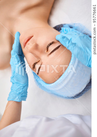 young beautiful woman receiving facial massage. spa 95776661