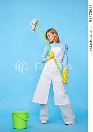 woman in rubber gloves and cleaner apron washing floor with mop woman in rubber gloves and cleaner apron washing floor with mop 95776685