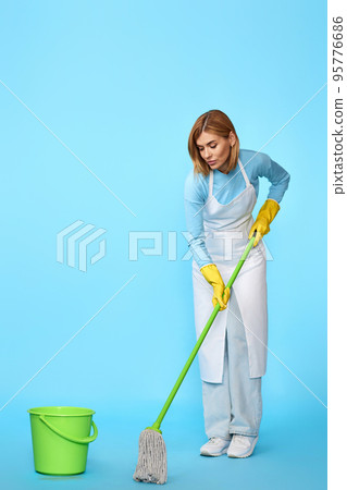 woman in rubber gloves washing floor with mop woman in rubber gloves washing floor with mop 95776686