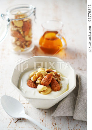 Mixed nuts and yogurt with honey 95776841