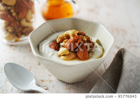 Mixed nuts and yogurt with honey 95776843