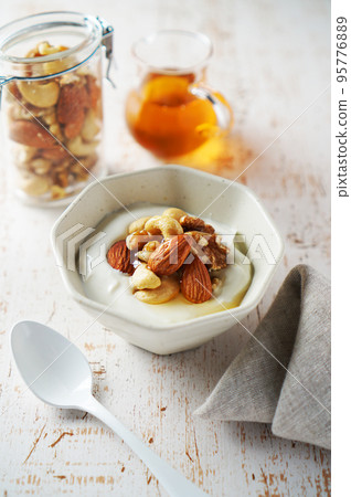 Mixed nuts and yogurt with honey 95776889