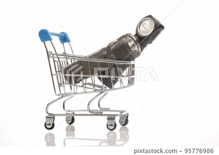 different flashlight in a grocery basket on a white background. different flashlight in a grocery basket on a white background. 95776986