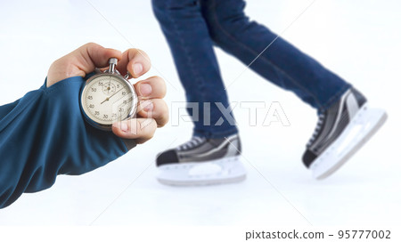 measuring speed on skates with a stopwatch. hand with a stopwatch 95777002