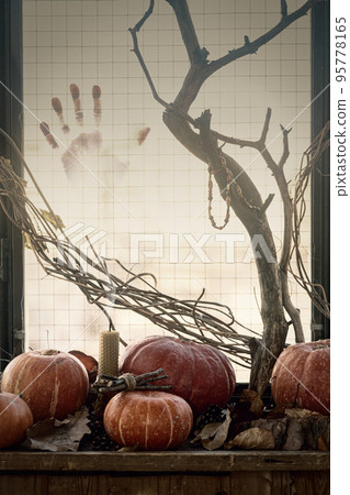 Horror vibes. Cloudy window with a bloody handprint and a pagan altar with pumpkins, dry twigs on wooden window sill, vertical photo, selected focus. Horror vibes. Cloudy window with a bloody handprint and a pagan altar with pumpkins, dry twigs on wooden window sill, vertical photo, selected focus. 95778165