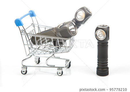 different flashlight in a grocery basket on a white background 95778210