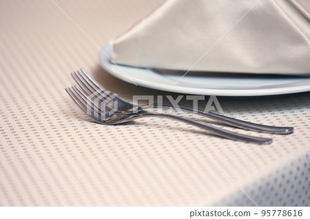 table setting forks on a table in the restaurant. table setting forks on a table in the restaurant. 95778616