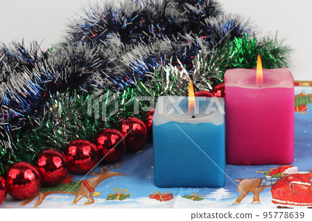 two burning candles with new year decoration two burning candles with new year decoration 95778639