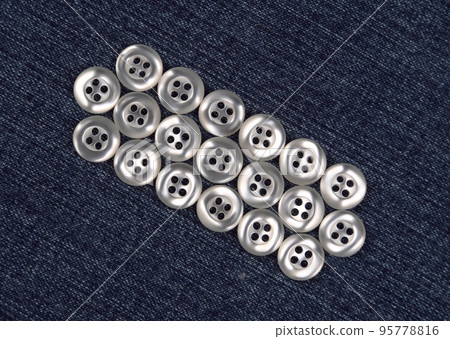 mother-of-pearl buttons on blue fabric mother-of-pearl buttons on blue fabric 95778816