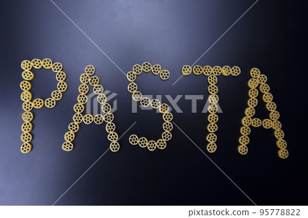 the word pasta is made of pasta on a dark background. 95778822