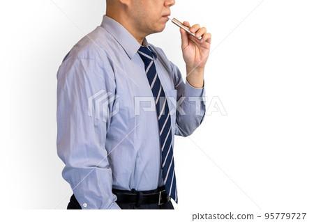 Businessman smoking a heated cigarette 95779727