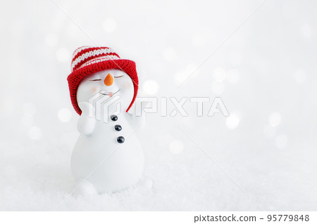 Happy snowman standing in winter christmas landscape. Merry christmas and happy new year greeting card. Funny snowman in hat on snowy background. Copy space for text 95779848